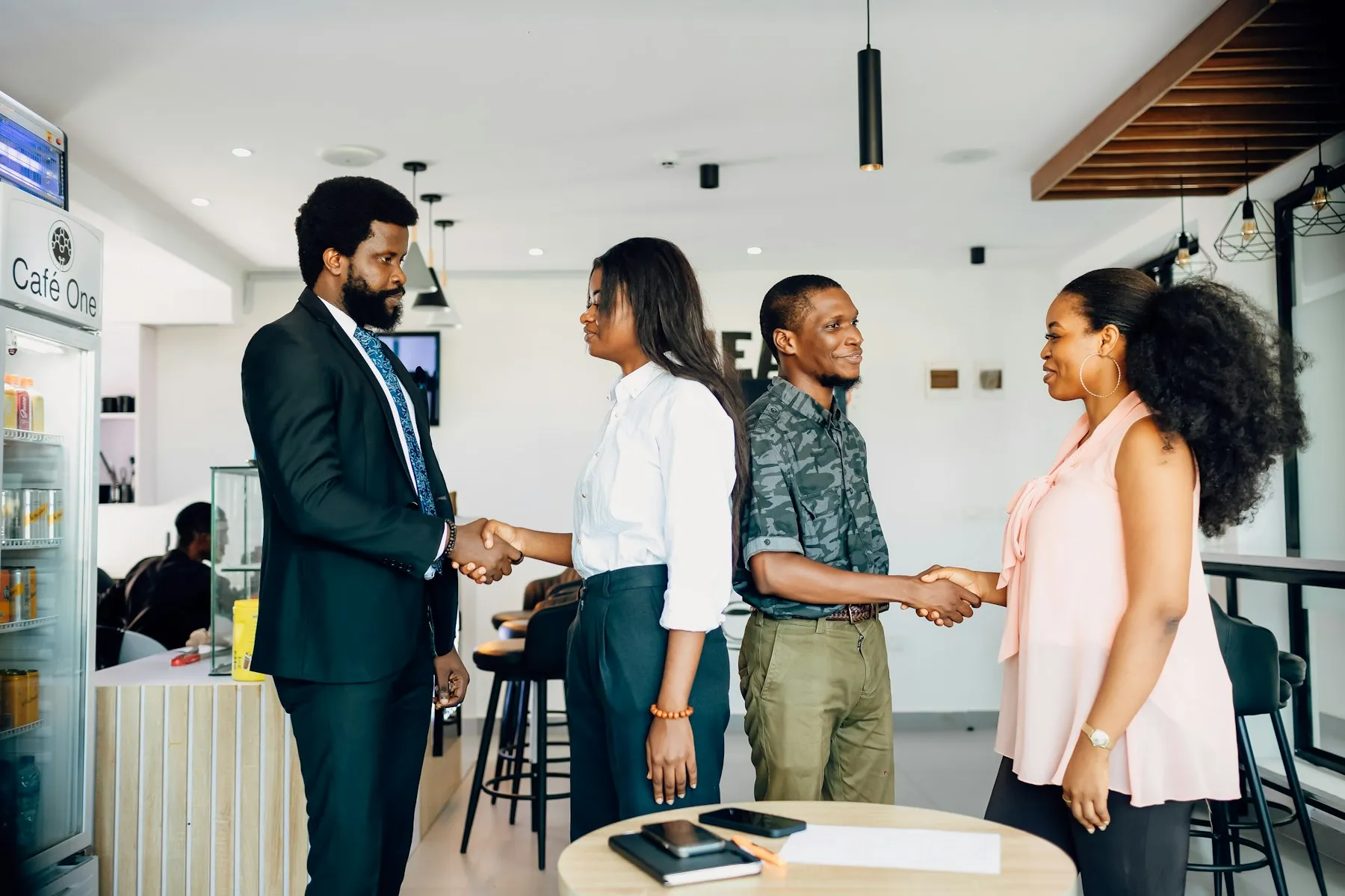 A team greeting each other in a bright modern office