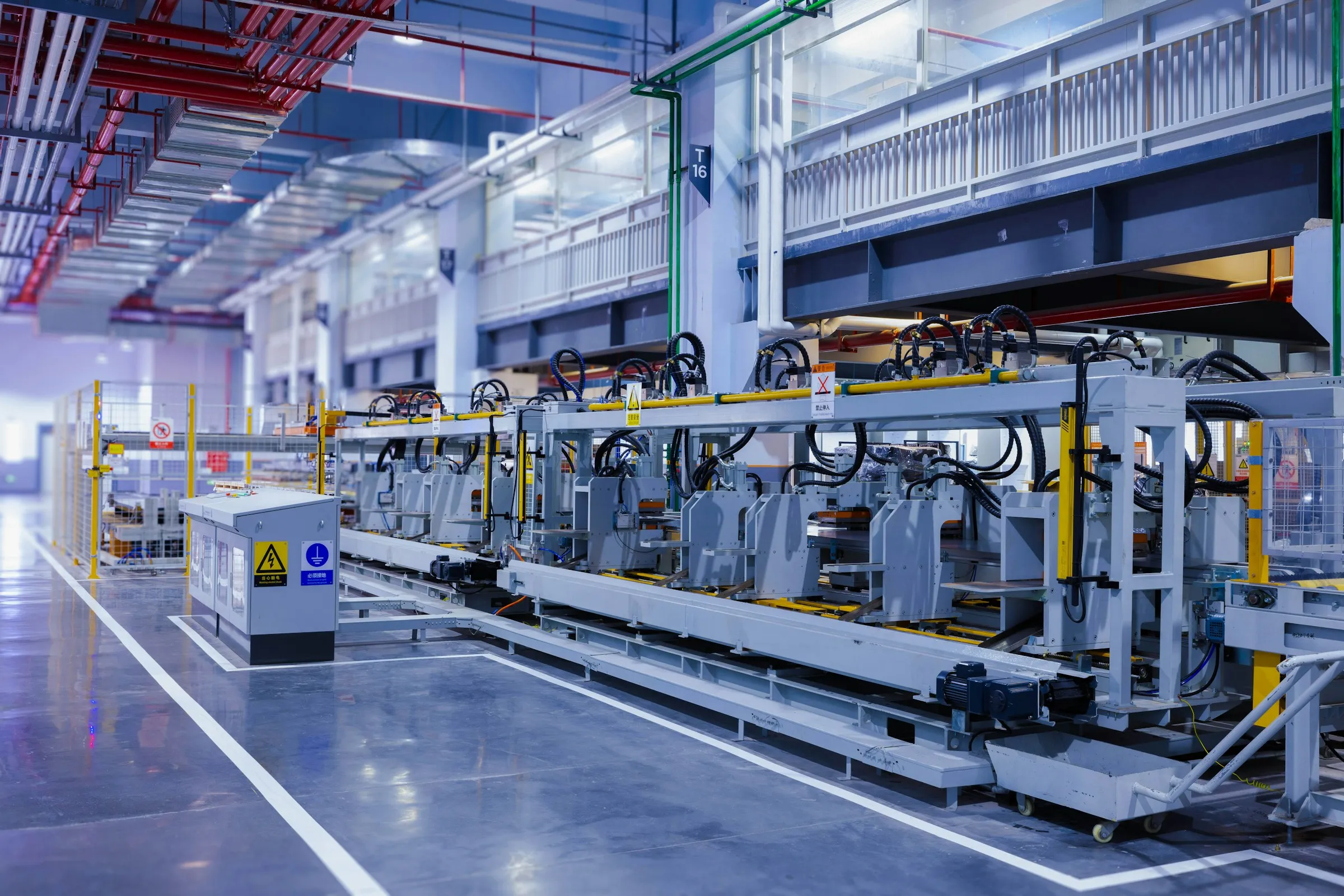 Automation line inside a modern production plant, lit in cool blue